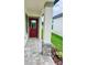 Covered front porch with a red door and decorative stone pillars at 3352 Cup Dr, Lakeland, FL 33803
