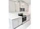Modern kitchen featuring gray cabinets, quartz countertops, and stainless steel appliances at 3352 Cup Dr, Lakeland, FL 33803