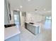 Open-concept kitchen with a large island, gray cabinets, and stainless steel appliances at 3352 Cup Dr, Lakeland, FL 33803
