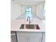 Kitchen island with a stainless steel sink and open-concept to the spacious living area at 3352 Cup Dr, Lakeland, FL 33803