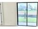Living room with a glass sliding door and a view of the lush backyard at 3352 Cup Dr, Lakeland, FL 33803