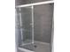 Sleek walk-in shower featuring glass doors and stylish gray tiling at 3352 Cup Dr, Lakeland, FL 33803