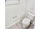 Small toilet room featuring a white toilet, gray tile flooring, and chrome fixtures at 3352 Cup Dr, Lakeland, FL 33803