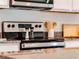 Close-up shot of a stainless steel stove on a granite countertop with white cabinets at 3629 Marlberry Way, Sanford, FL 32773