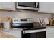 Modern kitchen featuring stainless steel appliances and granite countertops at 3635 Marlberry Way, Sanford, FL 32773