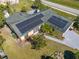 Up close aerial view of house showing the solar panels on roof at 401 Cart Ct, Kissimmee, FL 34759
