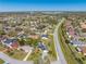 Drone shot of the house in its neighborhood, conveniently located near a main thoroughfare at 401 Cart Ct, Kissimmee, FL 34759