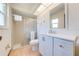 Bathroom with shower, white vanity, mirror, and tile floor at 401 Cart Ct, Kissimmee, FL 34759