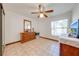 Comfortable bedroom featuring a ceiling fan and a dresser with a mirror at 401 Cart Ct, Kissimmee, FL 34759