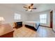 Bright bedroom with a ceiling fan, tile floors, and white walls at 401 Cart Ct, Kissimmee, FL 34759