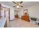 Bright bedroom featuring tile floors, a ceiling fan, and a dresser with a mirror at 401 Cart Ct, Kissimmee, FL 34759