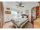 Comfortable bedroom features a ceiling fan, display cabinet, and natural light at 401 Cart Ct, Kissimmee, FL 34759