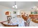 Cozy dining area with decorative chairs, a floral tablecloth, and a view into the living area at 401 Cart Ct, Kissimmee, FL 34759