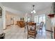 An open-concept dining area has checkerboard tile and a table for four at 401 Cart Ct, Kissimmee, FL 34759