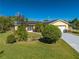 Charming yellow home with solar panels, landscaped yard and a long driveway at 401 Cart Ct, Kissimmee, FL 34759