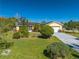 Charming yellow home with solar panels, landscaped yard and a long driveway at 401 Cart Ct, Kissimmee, FL 34759