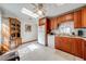 Bright kitchen with wood cabinets, white appliances, and checkerboard tile flooring at 401 Cart Ct, Kissimmee, FL 34759