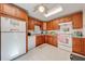 An efficient kitchen with a window above the sink, wood cabinets, and ample storage at 401 Cart Ct, Kissimmee, FL 34759