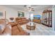 A well-lit living room features checkerboard floors and comfortable brown leather couches at 401 Cart Ct, Kissimmee, FL 34759