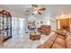 Spacious living room featuring tile flooring, a ceiling fan, and comfortable leather furniture at 401 Cart Ct, Kissimmee, FL 34759