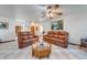 Bright living room with checkerboard tile, a ceiling fan, and comfortable seating at 401 Cart Ct, Kissimmee, FL 34759
