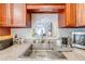Close-up of stainless steel sink, granite countertops and view into living area at 401 Cart Ct, Kissimmee, FL 34759