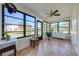 Enclosed sunroom with tile flooring, large windows, and views of the landscaped yard at 401 Cart Ct, Kissimmee, FL 34759