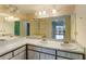 Bathroom featuring double sinks with bright lighting, ample counter space, and large mirror at 4117 Fairview Vista Pt # 206, Orlando, FL 32804