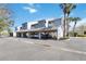 Carport parking area near a multi-story building with a clean asphalt surface and nearby palm trees at 4117 Fairview Vista Pt # 206, Orlando, FL 32804