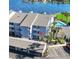 Three-story condo with a covered parking area, palm trees, and a pool on a body of water at 4117 Fairview Vista Pt # 206, Orlando, FL 32804