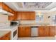 Traditional kitchen featuring wood cabinets, tile flooring, and stainless steel appliances at 4117 Fairview Vista Pt # 206, Orlando, FL 32804