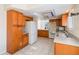 Traditional-style kitchen with wood cabinets, tile flooring, and white appliances at 4117 Fairview Vista Pt # 206, Orlando, FL 32804