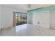 Bright living room featuring tile floors, modern wall accents, ceiling fan, and expansive glass doors providing natural light at 4117 Fairview Vista Pt # 206, Orlando, FL 32804