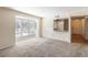 Bright living room with carpet and shutters overlooking the neighborhood at 4117 Fairview Vista Pt # 206, Orlando, FL 32804