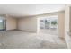 Bright living room with carpet and shutters overlooking the neighborhood at 4117 Fairview Vista Pt # 206, Orlando, FL 32804