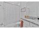 Bathroom featuring shower and tub with modern patterned shower curtain at 4484 Lions Gate Ave, Clermont, FL 34711