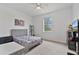 Bright bedroom with neutral walls, plush carpeting, and ample natural light from the window at 4484 Lions Gate Ave, Clermont, FL 34711