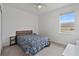 Inviting bedroom with neutral walls, plush carpeting, and ample natural light from the window at 4484 Lions Gate Ave, Clermont, FL 34711