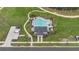 Aerial shot of a community pool with lounge chairs, palm trees and walking paths at 4484 Lions Gate Ave, Clermont, FL 34711