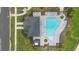 Aerial view of a pool and lounge chairs with a building and palm trees nearby at 4484 Lions Gate Ave, Clermont, FL 34711