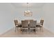 Formal dining area featuring a rustic wood table set with six upholstered chairs and decor at 4484 Lions Gate Ave, Clermont, FL 34711