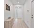 Bright entryway with wood-look flooring, modern decor, and a view of the front door at 4484 Lions Gate Ave, Clermont, FL 34711
