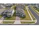 Aerial view of a two-story home with a brick driveway, two-car garage and solar panels at 4484 Lions Gate Ave, Clermont, FL 34711
