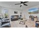 Bright living room featuring a plush gray sofa, a rug and a mounted TV at 4484 Lions Gate Ave, Clermont, FL 34711