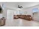 Spacious living room with luxury vinyl floors, neutral walls, large windows, and a plush sectional sofa at 4484 Lions Gate Ave, Clermont, FL 34711