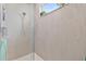 Modern shower with gray subway tile, glass door, a shower head, and a window for natural light at 4484 Lions Gate Ave, Clermont, FL 34711