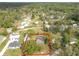 Expansive aerial view of a charming home surrounded by lush trees, highlighting the property's serene and private setting at 4502 Florence St, Apopka, FL 32712