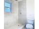 Modern bathroom featuring marble tile, shower, and toilet at 4502 Florence St, Apopka, FL 32712