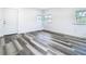 Bedroom features modern vinyl flooring, neutral paint, and ample natural light from multiple windows at 4502 Florence St, Apopka, FL 32712