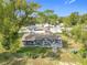 Charming single-story home with mature trees and a spacious yard, enclosed by a chain-link fence at 4502 Florence St, Apopka, FL 32712
